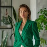 woman-green-suit-stands-front-window (1)